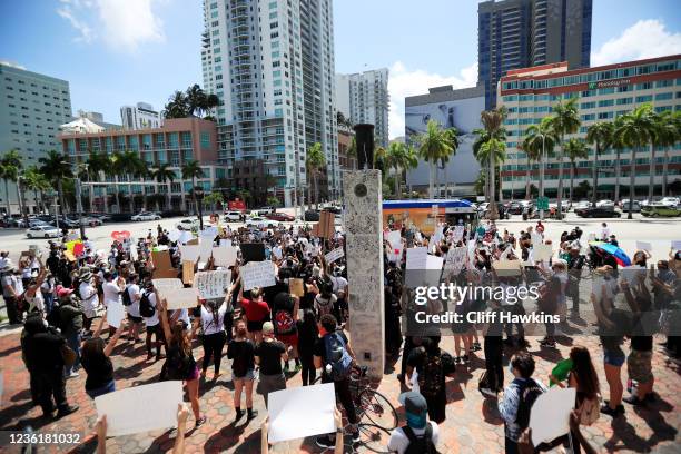 Activists hold a rally in response to the recent death of George Floyd at the Torch of Friendship in Bayfront Park on May 30, 2020 in Miami, Florida....