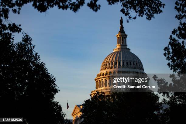 The U.S. Capitol building is seen at sunrise ahead of a meeting between U.S. President Joe Biden and House Democrats over continued negotiations on...