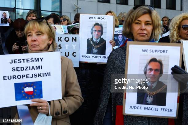 Judges and supporters hold banners with a picture of a suspended judge Maciej Ferek, during a rally in front of a court in support of judical...
