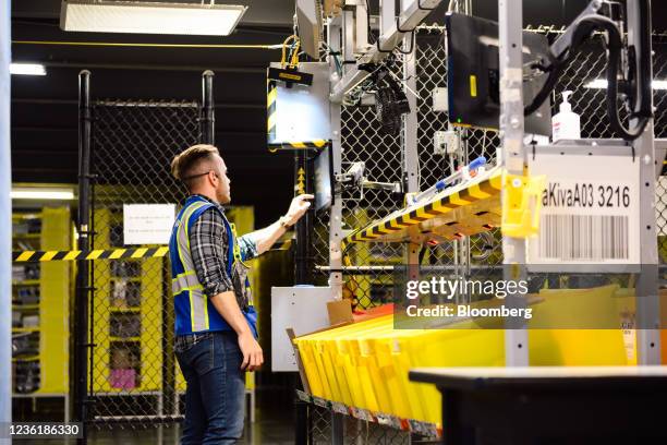 Worker inputs data while preparing orders for shipment at the Amazon.com BFI4 fulfillment center in Kent, Washington, U.S., on Thursday, Aug. 5,...