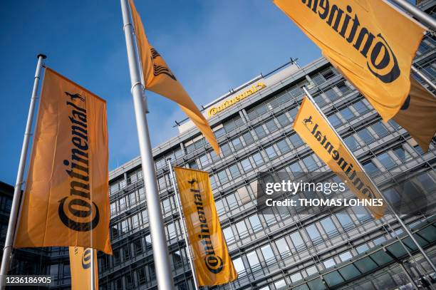 Flags flutter in the breeze outside the facility of German auto parts manufacturer Continental AG, in Frankfurt am Main, central Germany on October...