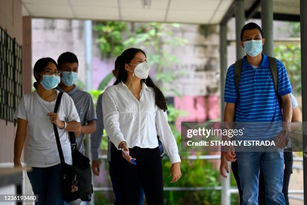 Marta Morales walks alongside her students at the Forever Foundation in Soyapango, El Salvador on October 19, 2021. - Marta, who lives in a populous...