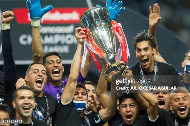 Monterrey's players celebrate with the trophy after winning the CONCACAF Champions League football match against America at the BBVA Bancomer stadium...