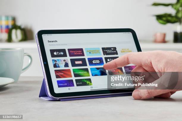 Detail of the Apple TV streaming app on the screen of an Apple iPad Mini, taken on October 6, 2021.