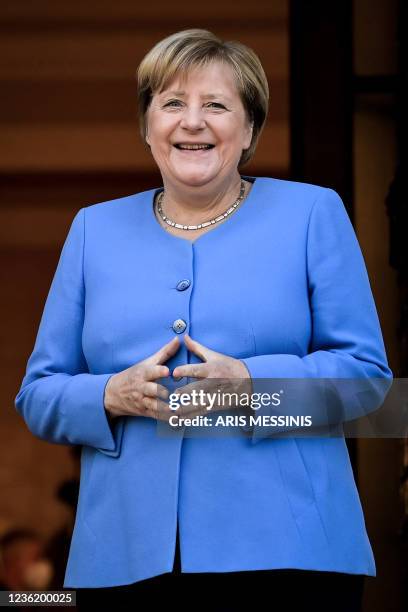 German Chancellor Angela Merkel poses for a photograph prior to a meeting with Greek Prime Minister during her visit in Athens on October 29, 2021.
