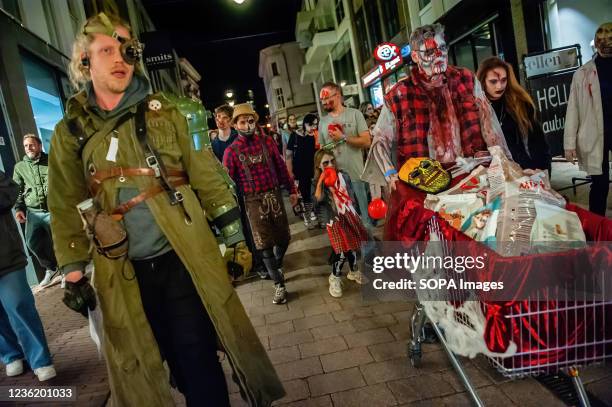 Zombie is seen with a shopping cart full of animal food donated by the zombies and people. Last two years the zombie walk was canceled due to the...