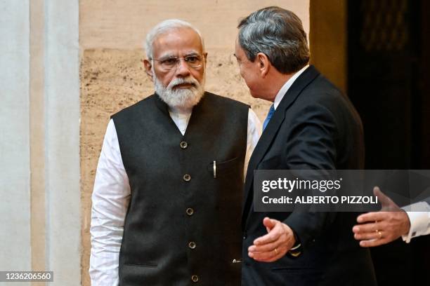 Italy's Prime Minister, Mario Draghi greets Indian Prime Minister Narendra Modi upon his arrival for their meeting at the Chigi palace in Rome on...