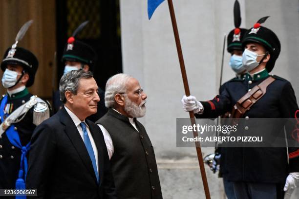 Italy's Prime Minister, Mario Draghi greets Indian Prime Minister Narendra Modi upon his arrival for their meeting at the Chigi palace in Rome on...