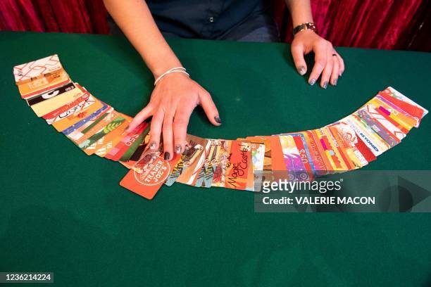 Magician Kayla Drescher practices with gift cards before her performance at the Magic Castle, in Hollywood, California on October 13, 2021. Sitting...
