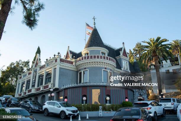 People arrive at the Magic Castle, in Hollywood, California on October 13, 2021. - The stereotype of a magician in a top hat sawing his glamorous,...