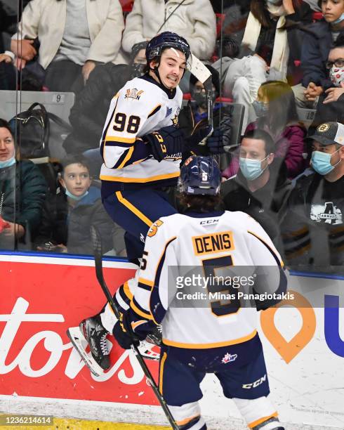 Xavier Bourgault of the Shawinigan Cataractes jumps up as he celebrates his goal with teammate Lou-Felix Denis against the Blainville-Boisbriand...