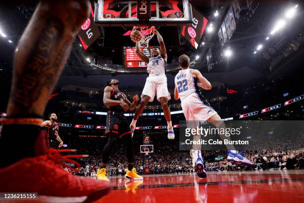 Wendell Carter Jr. #34 of the Orlando Magic slams the ball as Precious Achiuwa of the Toronto Raptors looks up during the first half of their NBA...