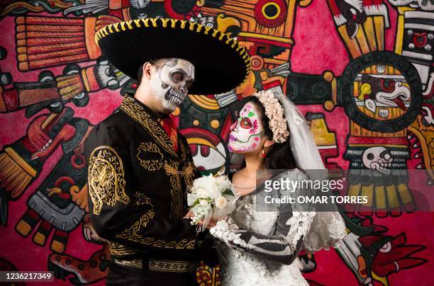 Actress Nadia Hernandez and actor Henry Alva pose for a photograph representing the legendary actor Pedro Infante and one of the characters acting as...