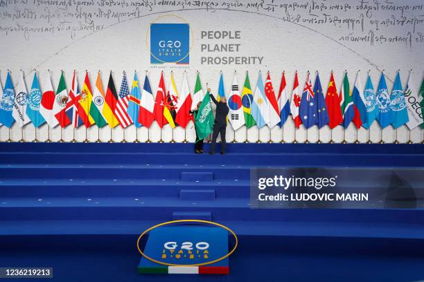 Employees arrange the Saudi Arabian flag during the final preparations before world leaders gather for the official family photograph on day one of...