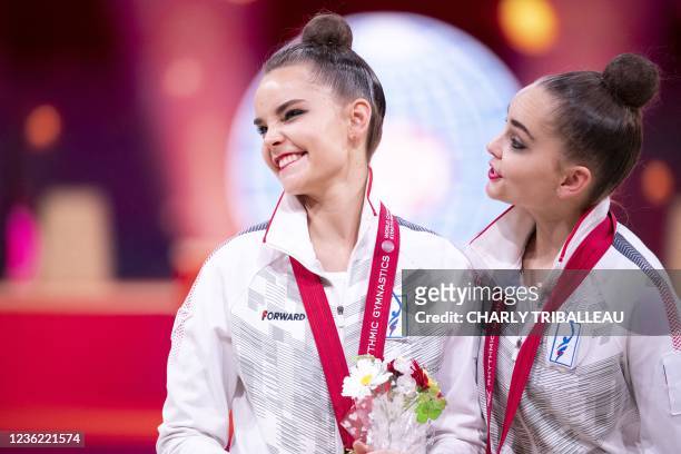 Gold medallist Russia's Dina Averina and bronze medallist Russia's Arina Averina react during the medal ceremony for the individual all-around final...