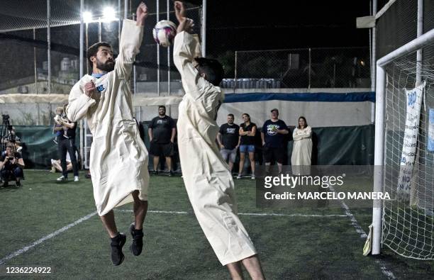 New member of the Maradonian church simulates making late Argentine football star Diego Maradona's hand of God, a goal made against England during...