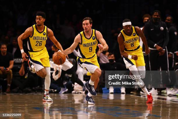 McConnell, Justin Holiday, and Jeremy Lamb of the Indiana Pacers in action against the Brooklyn Nets at Barclays Center on October 29, 2021 in New...