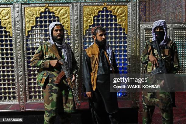 Taliban fighters stand guard near a tomb inside the Hazrat-e-Ali shrine or Blue Mosque, in Mazar-i-Sharif on October 30, 2021.