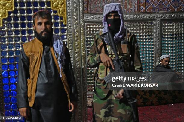 Taliban fighters stand guard near a tomb inside the Hazrat-e-Ali shrine or Blue Mosque, in Mazar-i-Sharif on October 30, 2021.