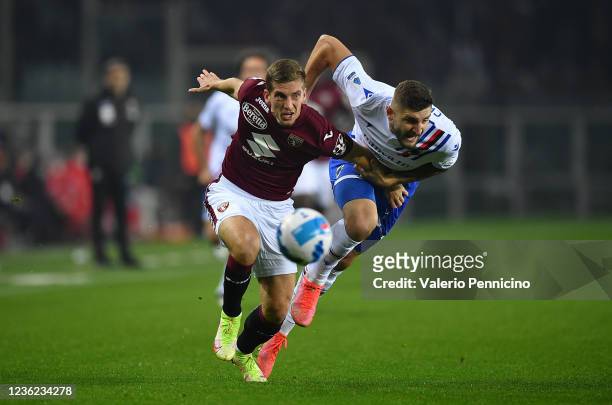Dennis Praet of Torino FC is challenged by Julian Chabot of UC Sampdoria during the Serie A match between c at Stadio Olimpico di Torino on October...