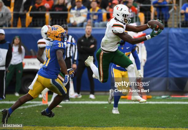 Key'Shawn Smith of the Miami Hurricanes makes a catch in the end zone for a 13-yard touchdown reception as Erick Hallett of the Pittsburgh Panthers...