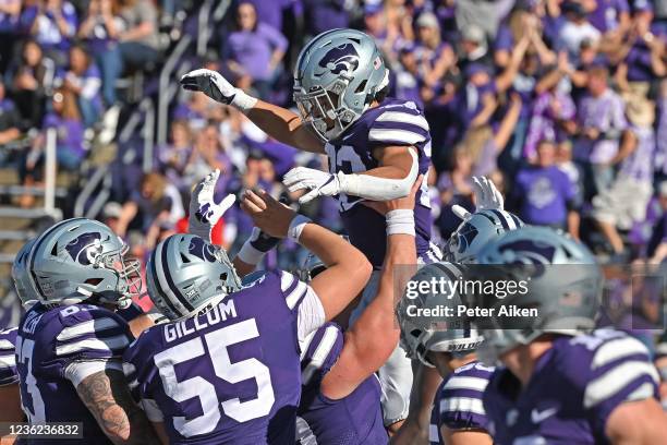 Running back Deuce Vaughn of the Kansas State Wildcats celebrates with his teammates after scoring a touchdown against the TCU Horned Frogs during...