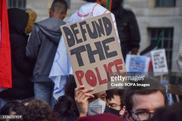 Protester holds a 'Defund The Police' placard during the demonstration outside Downing Street. Protesters marched from Trafalgar Square to Downing...