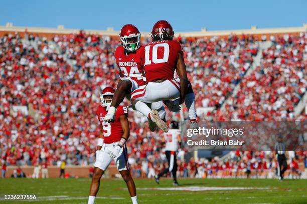 Safety Patrick Fields of the Oklahoma Sooners celebrates after intercepting a tipped pass with linebacker Brian Asamoah against the Texas Tech Red...