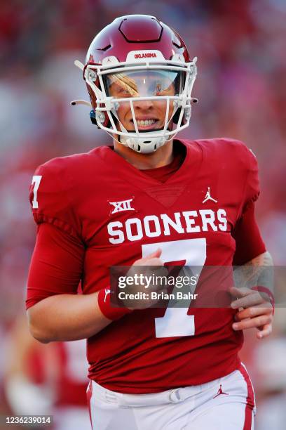 Quarterback Spencer Rattler of the Oklahoma Sooners smiles after throwing a 42-yard pass to the end zone for a touchdown against the Texas Tech Red...