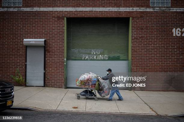 Canner' Laurentino Marin looks for cans and bottles to recycle in a neighborhood in Brooklyn on October 27, 2021. Marin, who is 80, is one of New...