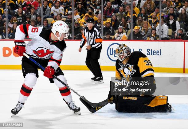 Tristan Jarry of the Pittsburgh Penguins makes a save against Jimmy Vesey of the New Jersey Devils at PPG PAINTS Arena on October 30, 2021 in...