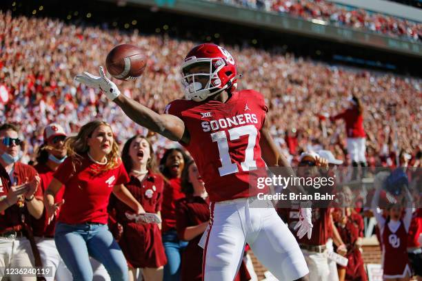 Wide receiver Marvin Mims of the Oklahoma Sooners pops and rolls the ball off his fingertips after scoring on a 67-yard catch and run for a touchdown...