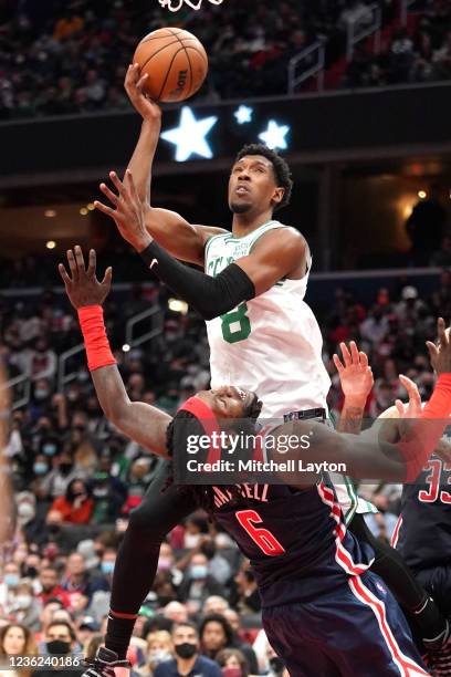 Josh Richardson of the Boston Celtics drives to the basket over Montrezl Harrell of the Washington Wizards in the fourth quarter during a NBA...