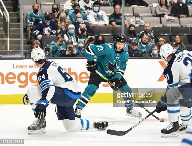 Nick Bonino of the San Jose Sharks looks to make a pass against the Winnipeg Jets in a regular season game at SAP Center on October 30, 2021 in San...