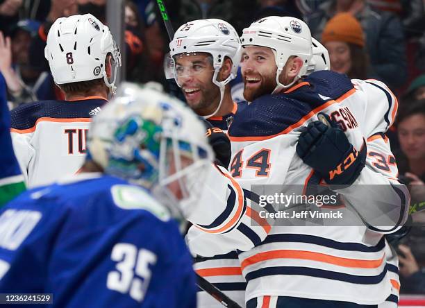 Warren Foegele of the Edmonton Oilers is congratulated by teammates after scoring during their NHL game against the Vancouver Canucks at Rogers Arena...