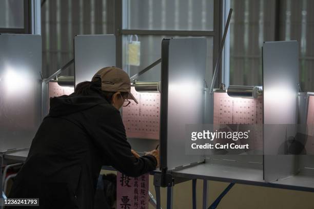 Woman casts her vote in the general election on October 31, 2021 in Tokyo, Japan. Residents have taken to the polls today in a general election that...