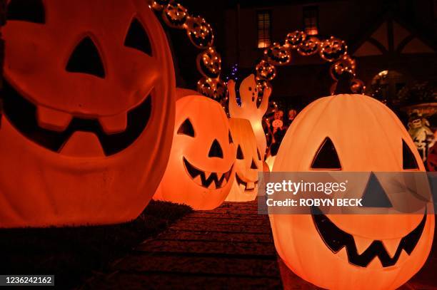 Home is decorated with pumpkins and ghosts for Halloween, in Burbank, California, October 30, 2021. - Last year's Halloween celebrations were...
