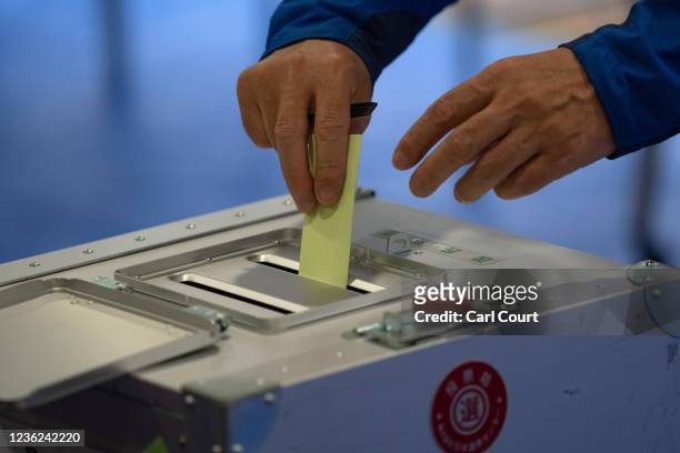Man casts his vote in the general election on October 31, 2021 in Tokyo, Japan. Residents have taken to the polls today in a general election that is...