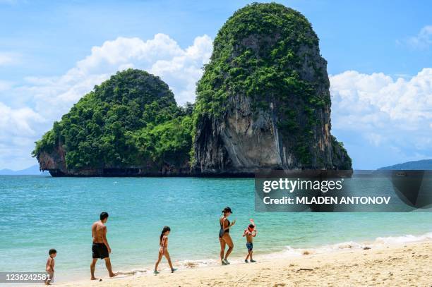 Picture taken on October 30, 2021 shows tourists enjoying Phra Nang Beach in Krabi on October 30, 2021 as the country prepares to welcome visitors...