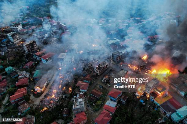 This aerial photo taken on October 29, 2021 show smokes and fires from Thantlang, in Chin State, where more than 160 buildings have been destroyed...