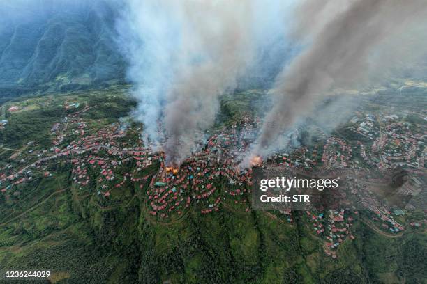 This aerial photo taken on October 29, 2021 show smokes and fires from Thantlang, in Chin State, where more than 160 buildings have been destroyed...