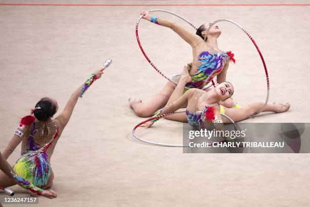 Team Japan compete in the group three hoops and two pairs of clubs final during the Rhythmic Gymnastics World Championships at the West Japan General...