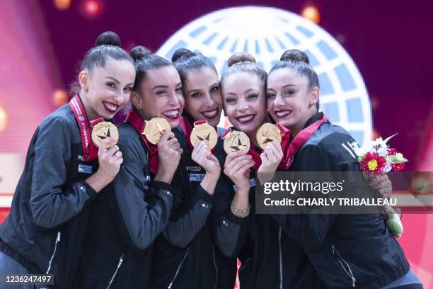 Gold medallists team Italy pose on the podium after the group three hoops and two pairs of clubs final during the Rhythmic Gymnastics World...