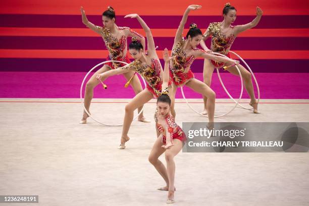 Team China compete in the group three hoops and two pairs of clubs final during the Rhythmic Gymnastics World Championships at the West Japan General...