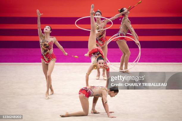 Team China compete in the group three hoops and two pairs of clubs final during the Rhythmic Gymnastics World Championships at the West Japan General...