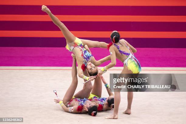 Team Japan compete in the group three hoops and two pairs of clubs final during the Rhythmic Gymnastics World Championships at the West Japan General...
