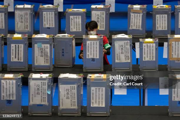 An electoral official carries a ballot box into a counting centre during Japans general election on October 31, 2021 in Tokyo, Japan. Japan took to...