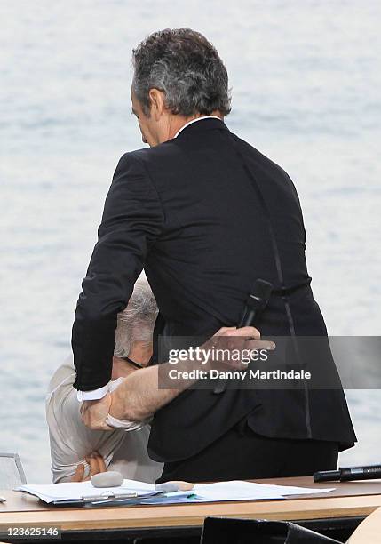 Woody Allen fall over into TV presenter Michel Denisot as he walks on stage for the Chanel+ program 'Le Grand Journal' at Majestic Beach Pier on May...