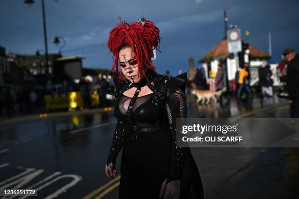 Participant walks through town during the biannual 'Whitby Goth Weekend' festival in Whitby, northern England, on October 31, 2021. - The festival...