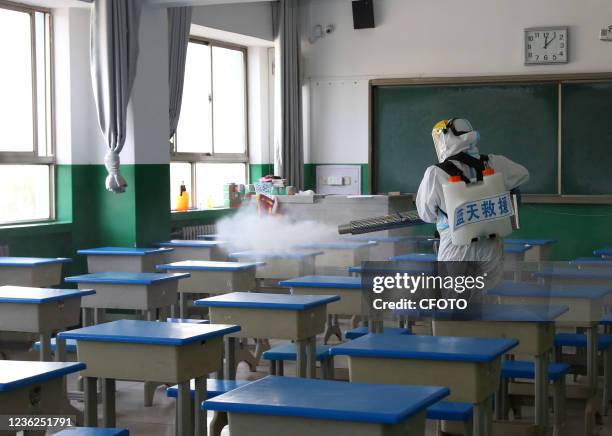 Rescue team of Blue Sky carries out disinfection and epidemic prevention work at a middle school in Pingliang City, Northwest China's Gansu Province,...